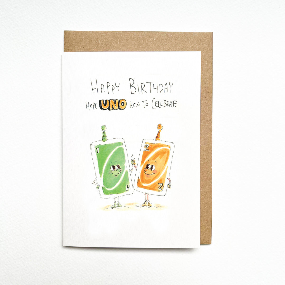 Happy Birthday, Hope UNO How to Celebrate – a pair of smiling green and orange UNO-style cards, complete with birthday party hats by Well Drawn Melbourne. Front product photo.