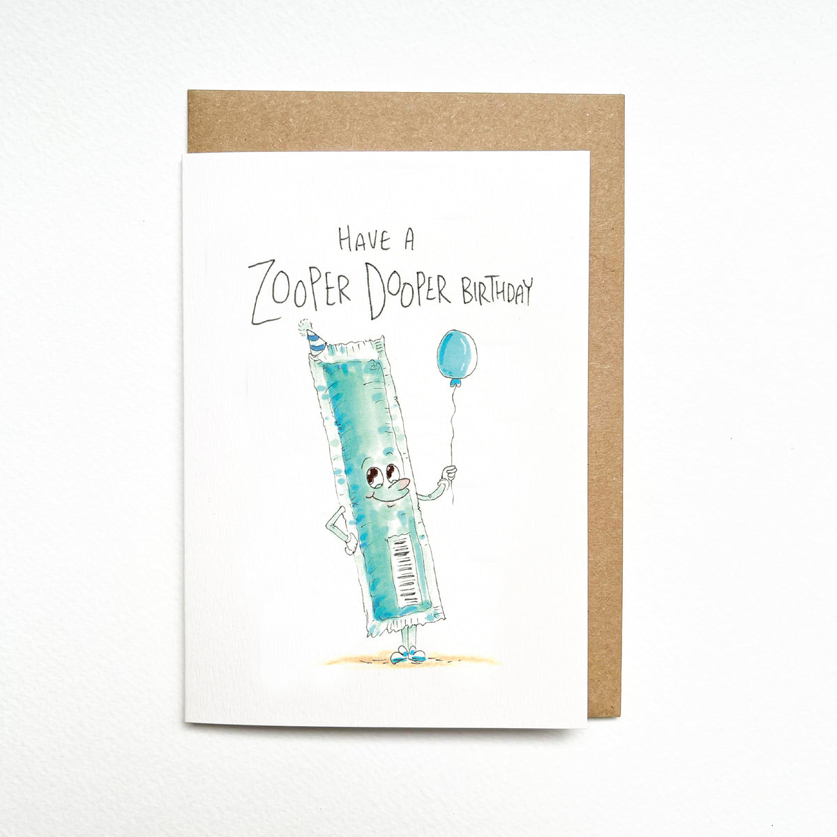 Have a Zooper Dooper Birthday – a grinning blue Zooper Dooper-style ice block in a party hat, holding a balloon by Well Drawn Melbourne. Front product photo.
